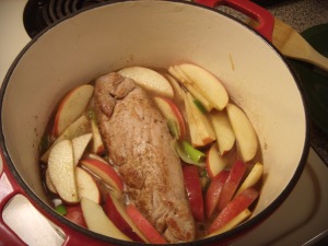Sliced apples and leeks snuggling up close to the browned pork tenderloin, ready to be popped into the oven.